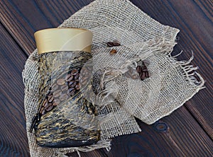 Decorated jar with coffee on a rough cloth napkin