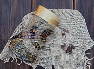 Decorated jar with coffee on a rough cloth napkin