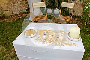 Decorated marriage table for secular wedding ceremony with sandy beach ocean concept shell and candle