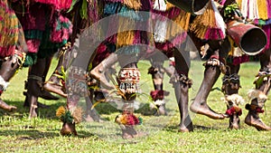 Shell jewelry on legs stomp the rhythm. Dancer with raffia skirts on island in South Pacific Ocean. photo