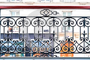 Decorated metal fence of a balcony by the street