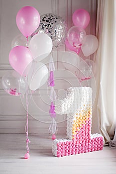 Decorated number 1 for a first birthday and balloons