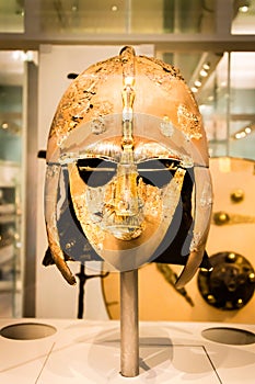 Decorated and ornate Anglo-Saxon helmet creating the image of a man joined by a dragon`s head