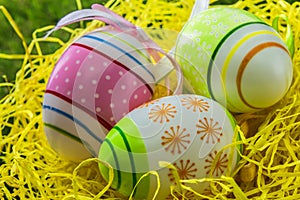 Decorated painted Easter eggs on yellow straw