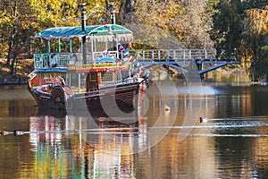 Decorated pleasure boat floats in middle of river