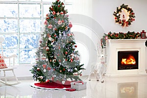 Decorated room with Christmas tree and fireplace