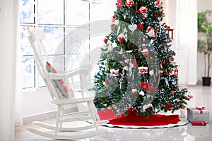 Decorated room with Christmas tree and fireplace