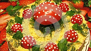 Decorated salad. For decoration are used tomatoes, greens and mayonnaise.