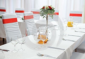 Decorated served party table with vase with flowers