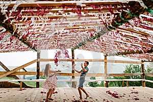 Decorated Shalash, tents, tent, awning, canopy, scene. Dance. Wedding. pregnant woman, husband throwing red, white decor paper
