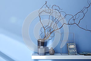 Decorated shelf on blue wall modern interior design