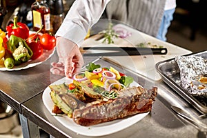 Decorated with a sprig of rosemary. the chef prepares in the restaurant. Grilled rack of lamb with fried potatoes and