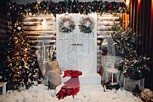 Decorated studio for Christmas holiday with doors in center.