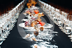 Decorated table with glasses and pure snow for Christmas or other holidays