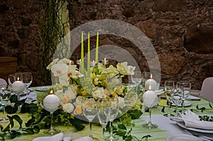 Decorated table with table compositions and burning candles