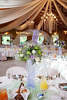 Decorated tables with candelabra at wedding reception, selective photo