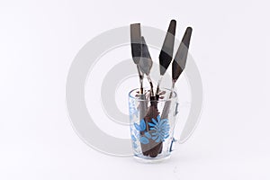 Decorated transparent glass full of spatulas