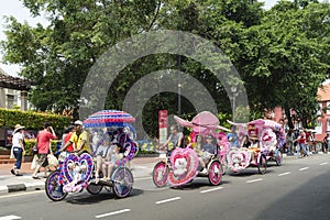 Decorated trishaw with colorful flowers and doll for hire at Malacca city, Malaysia