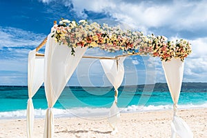 Decorated wedding arch on Puka beach at Boracay island photo