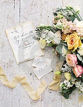 Decorated wedding composition on the table with beautiful flowers and words bride and groom, outdoor, fine art.