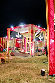 A decorated wedding gazebo in india in a landscaped garden