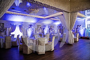 Decorated wedding hall with dance floor and blue light