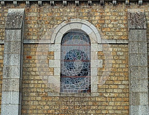 Decorated window on stone bricks wall at cathedral