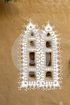 Decorated windows of a loam hut