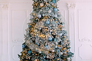 Decorated xmas tree on white wall background