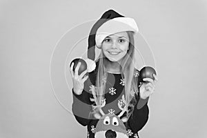Decorating christmas tree. Girl smiling face hold balls ornaments blue background. Let kid decorate christmas tree