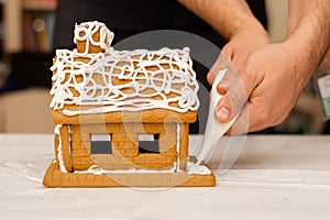 Decorating, cooking, slaking a gingerbread house. Preparation for Christmas