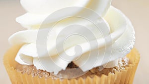Decorating cup-cake with cream. Using cooking bag, confectioner making cupcakes for party.
