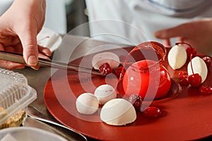 Decorating dessert with raspberries