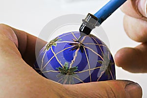 Decorating easter eggs with wax and a kistka