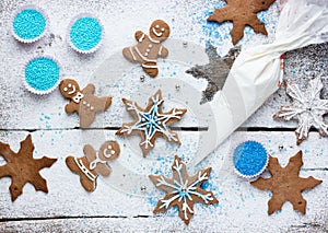 Decorating gingerbread man and snowflake Christmas cookie background, Christmas treats for kids cooking process