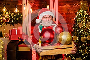 Decorating home. Christmas spirit. Cheerful celebration. Christmas decoration. Santa Claus. Mature man with white beard