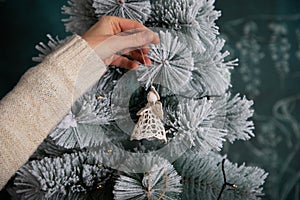 decorating snowy Christmas tree at home