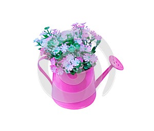 Decoration artificial multicolored flowers in pink watering can isolated on white background with clipping path
