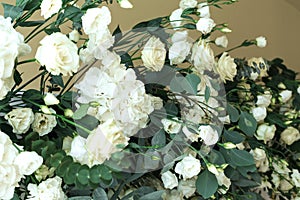 Decoration of the banquet hall, photo zone and wedding arch with eucalyptus leaves, hydrangea and eustoma in the wedding hall.