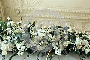 Decoration of the banquet hall, photo zone and wedding arch with eucalyptus leaves, hydrangea and eustoma in the wedding hall.