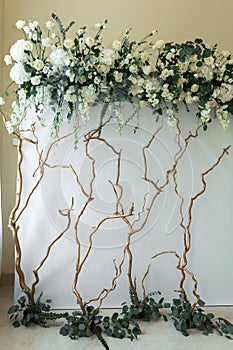 Decoration of the banquet hall, photo zone and wedding arch with eucalyptus leaves, hydrangea and eustoma in the wedding hall.