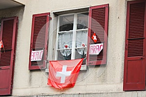 Decoration on a building on Swiss National Day. National holiday of Switzerland, set on 1st August. Celebration of founding of