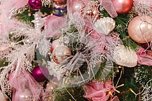 Decoration of the Christmas tree with pink and white balls