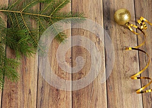 Decoration for christmas on a wooden background. Christmas tree branch and balls for the Christmas tree. New Year celebration.