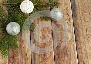 Decoration for christmas on a wooden background. Christmas tree branch and balls for the Christmas tree. New Year celebration.