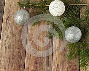 Decoration for christmas on a wooden background. Christmas tree branch and balls for the Christmas tree. New Year celebration