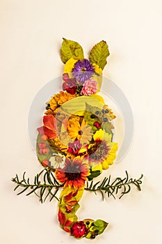 decoration from colorful autumnal leaves, berries and flowers, creative craft