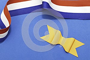 Decoration for the Dutch fest of Koningsdag with an orange paper bow