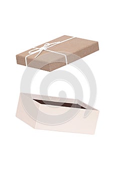 Decoration element isolated. Close-up of a open brown white present or gift box with white ribbon bow isolated on a white