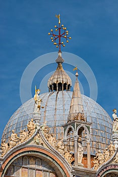 Decoration elements at roofs and cupolas of Basilica San Marco in Venice, Italy, at sunny day and deep blue sky